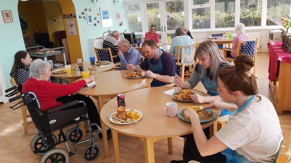 Staff and residents eating together