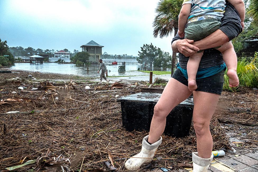 A family checks their belongings in the town of Jena after Hurricane Idalia made landfall near Keaton Beach, Florida, USA, 30 August 2023