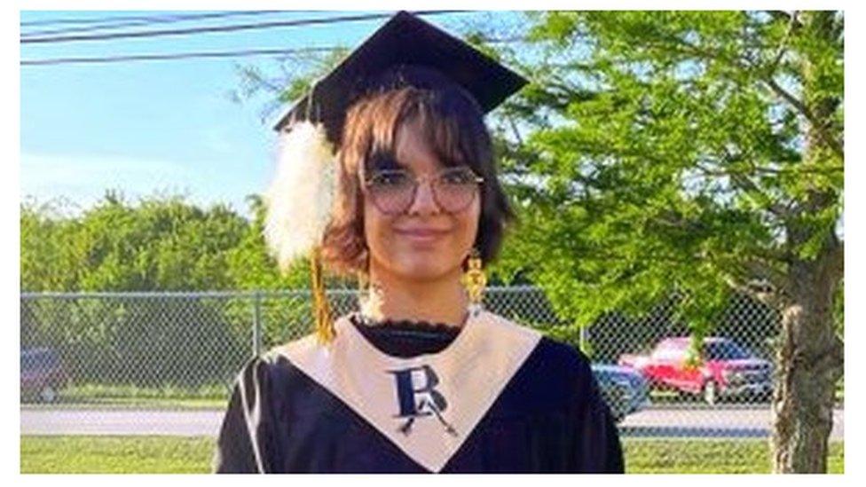 A photo of Lena Black wearing her sacred eagle plume on her graduation cap