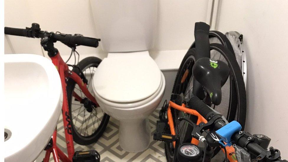 Two bikes parked next to a toilet