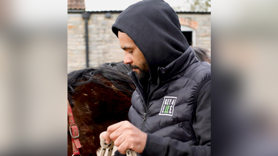 Image of Trueman next to a horse