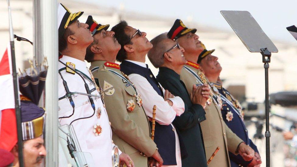 Pakistan's then Prime Minister Imran Khan and President Arif Alvi watch Pakistan's Air Force fighter jets perform during the Pakistan Day parade in Islamabad on March 23, 2022