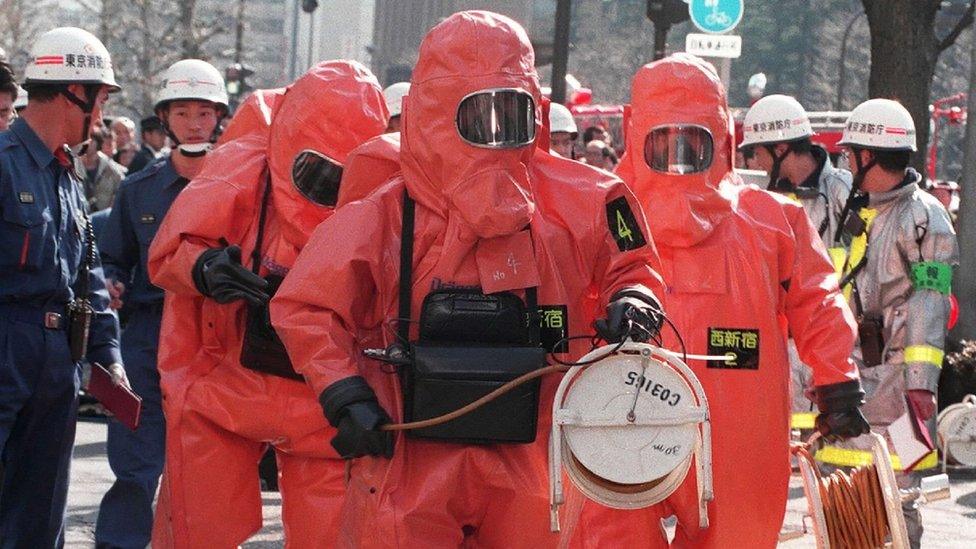 Police in hazmat suits at the site of the 1995 attack