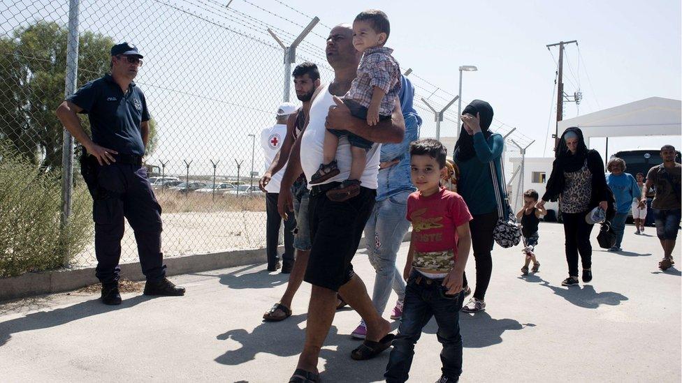 Refugees fleeing war in Syria arrive at a refugee camp in Cyprus