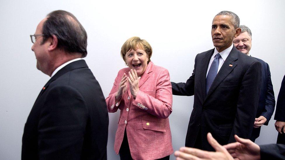 Angela Merkel, centre, laughs expressively with hands to her mouth, while Francois Hollande, left, and Mr Obama, right, remain impassive.