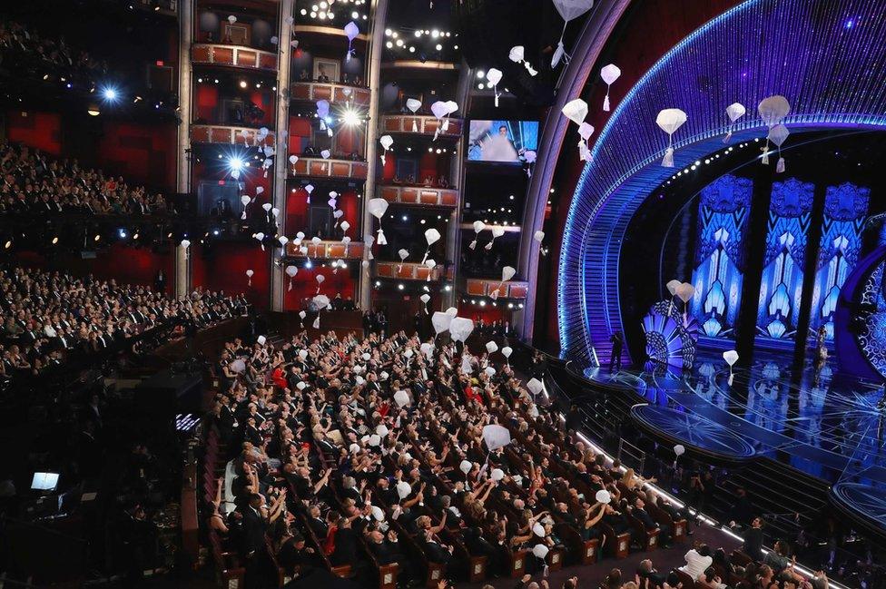 Candy is delivered from the rafters to the audience