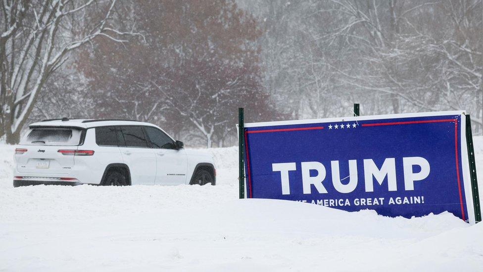 sign sits in the snow outside former U.S. President Donald Trump's campaign headquarters in Urbandale, Iowa