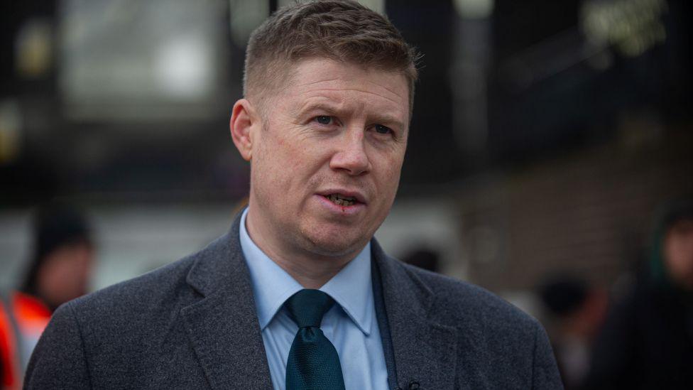 RMT general secretary Eddie Dempsey who is wearing a blue shirt, tie and jacket.