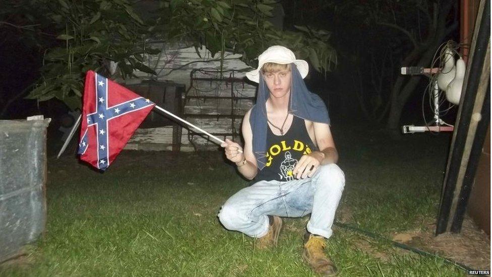 Dylann Roof posing with the flag