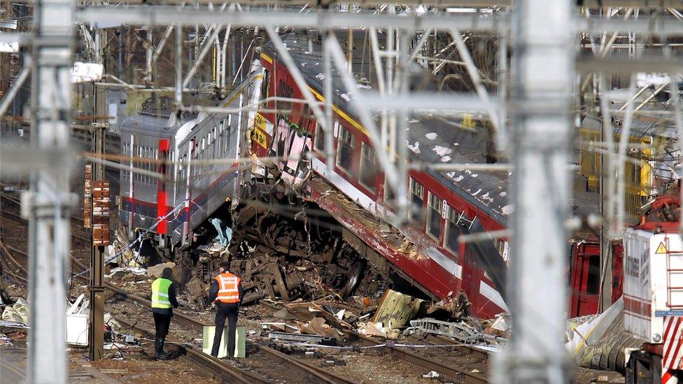 Technicians assess the wrecks of the trains that collided near the Buizingen train station in Halle, 21 February 2010