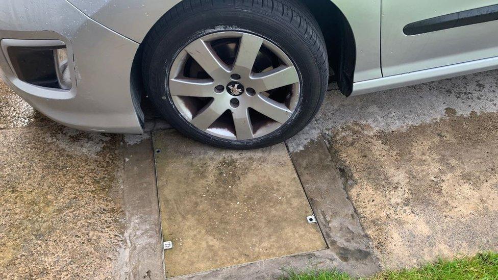 Mr Barber's car in his flooded driveway