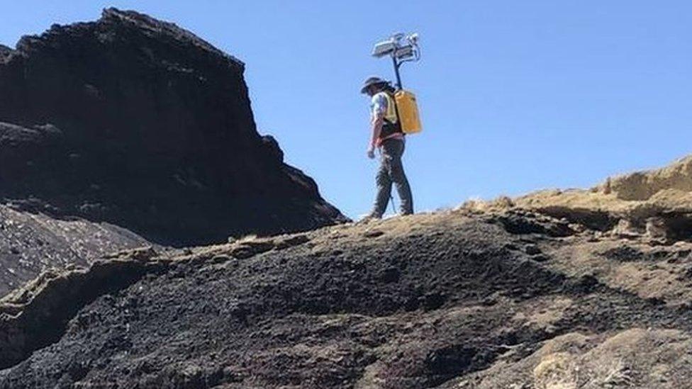 Nasa worker testing out the high tech backpack in New Mexico