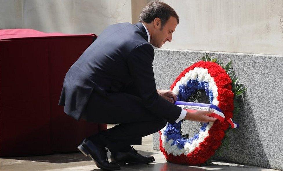 Emmanuel Macron lays a wreath at the statue of Queen Elizabeth, the Queen Mother