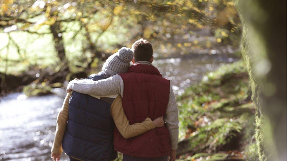 Couple walking by a river