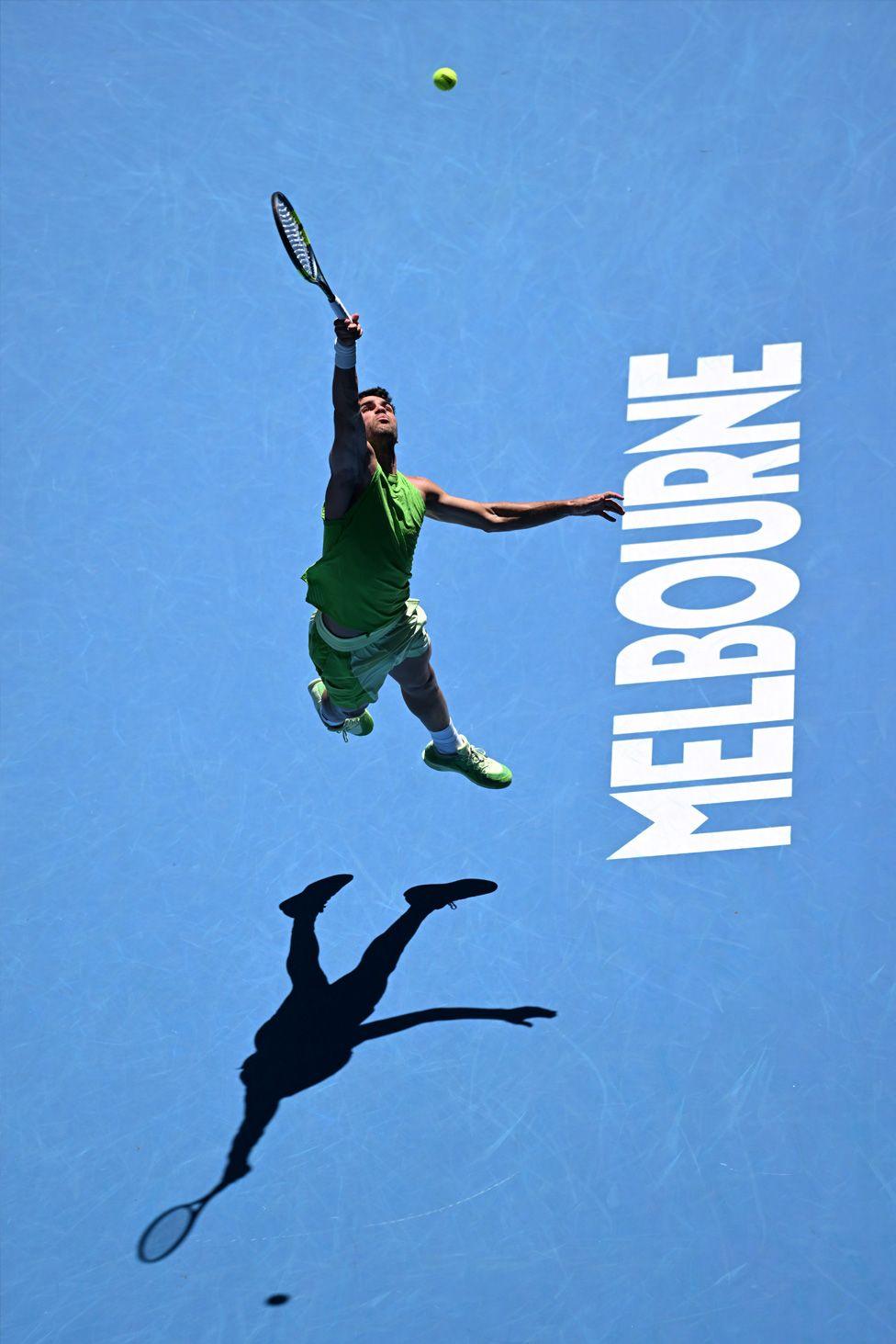 Carlos Alcaraz attempts an acrobatic return against France's Corentin Moutet in the Australian Open third round. Photo by Chloe Davis