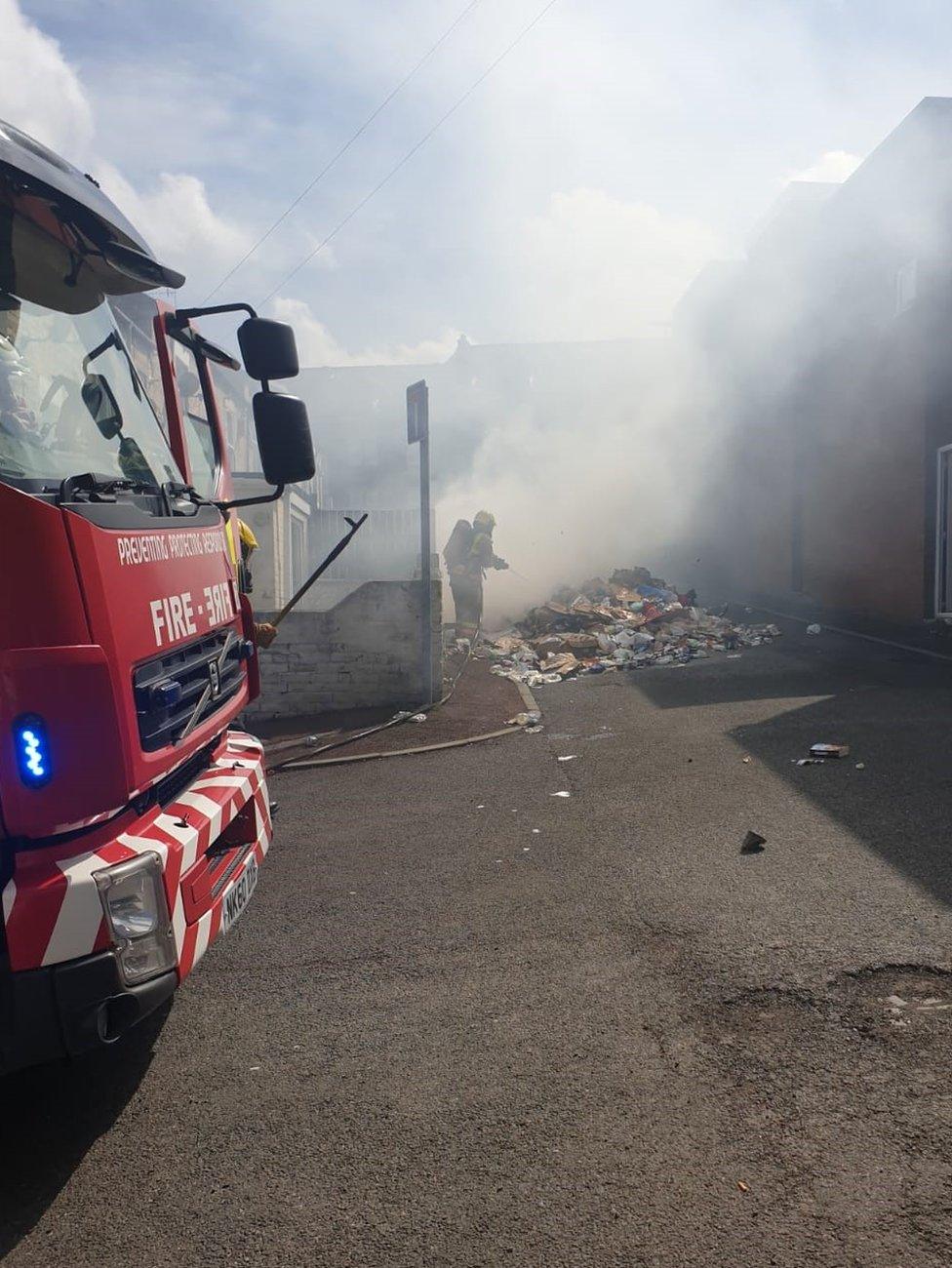 A firefighter helps extinguish the blaze