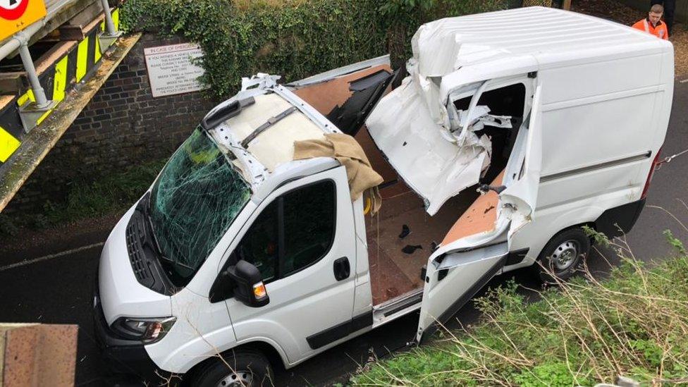 Van at railway bridge