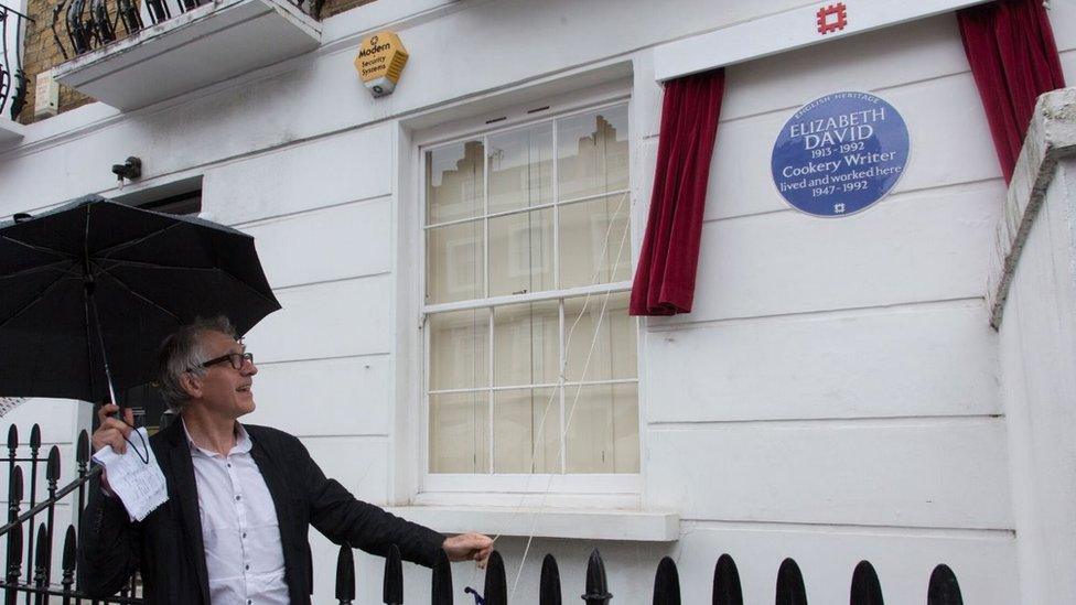 Man looks at Elizabeth David plaque