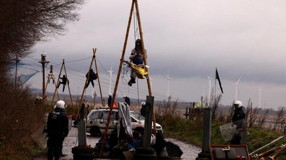 Police keep guard as activists stage a sit-in protest against the expansion of the Garzweiler open-cast lignite mine of Germany's utility RWE, in Luetzerath, Germany, January 11, 2023