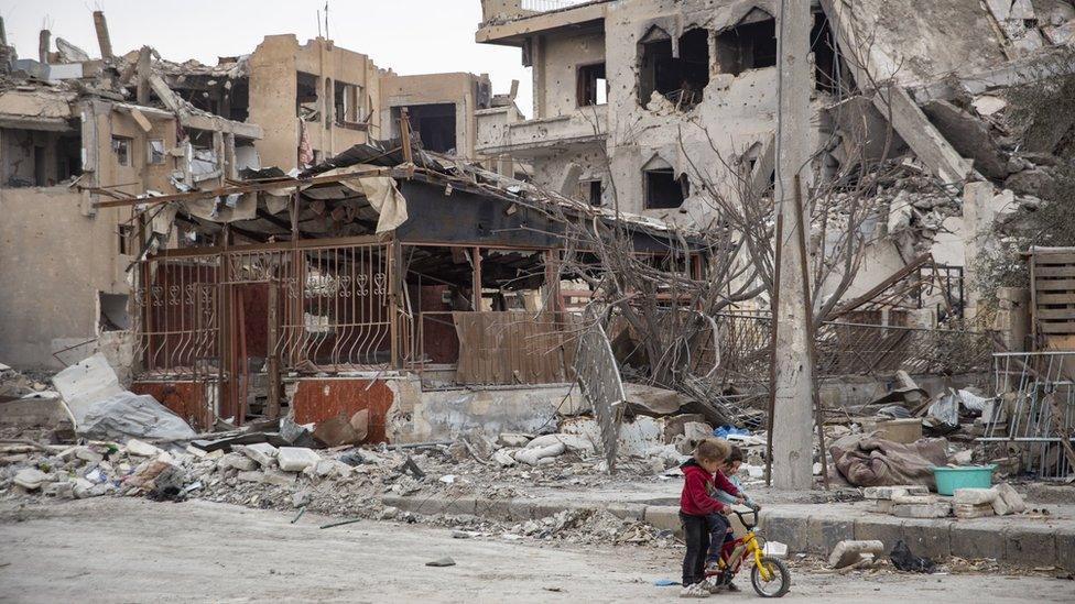 Children in front of rubble