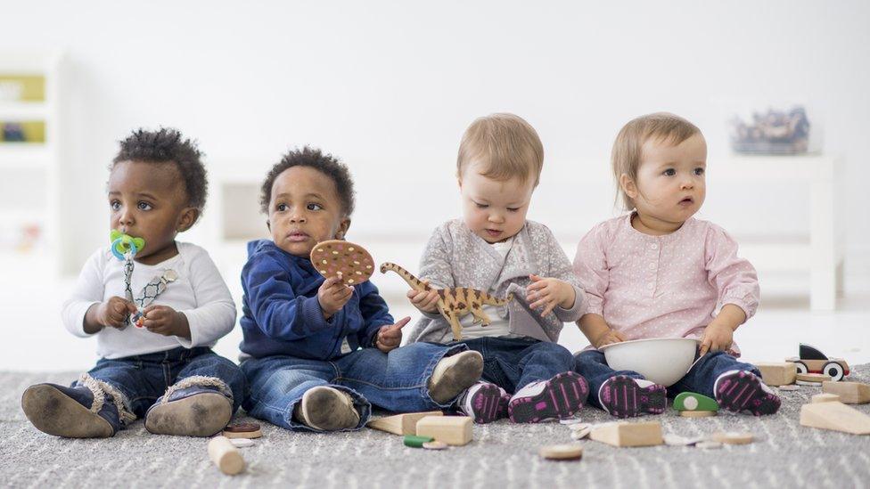 Babies-sitting-in-a-row.