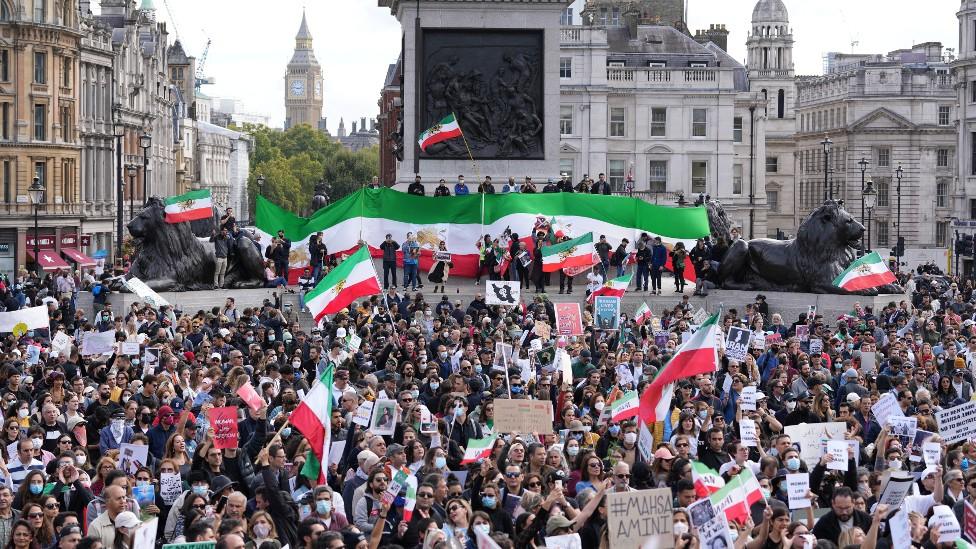 People in Trafalgar Square protesting the death of Mahsa Amini