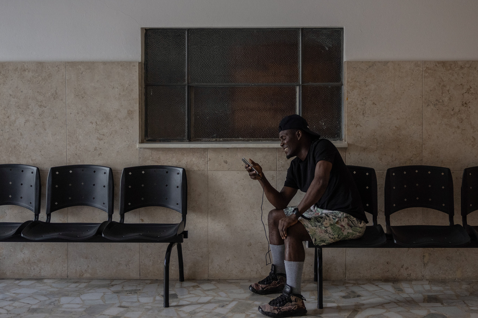 Roman Friday makes a video call to his family back home. (Victor Moriyama/BBC)