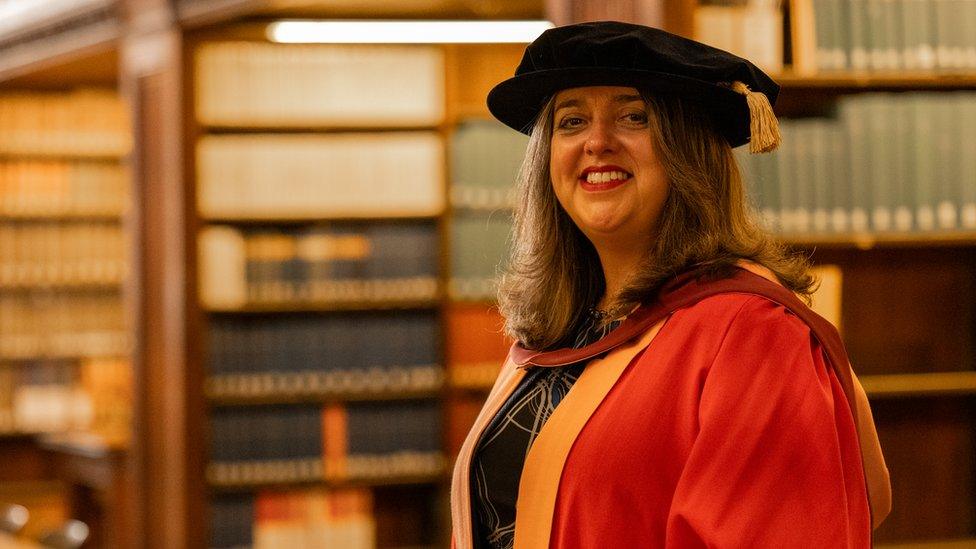 Alex Ardalan-Raikes MBE in graduation robe