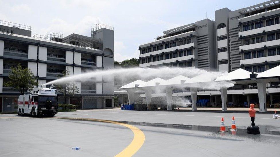 Hong Kong Police demonstrate their new water cannon equipped vehicle at the Police Tactical Unit compound in Hong Kong