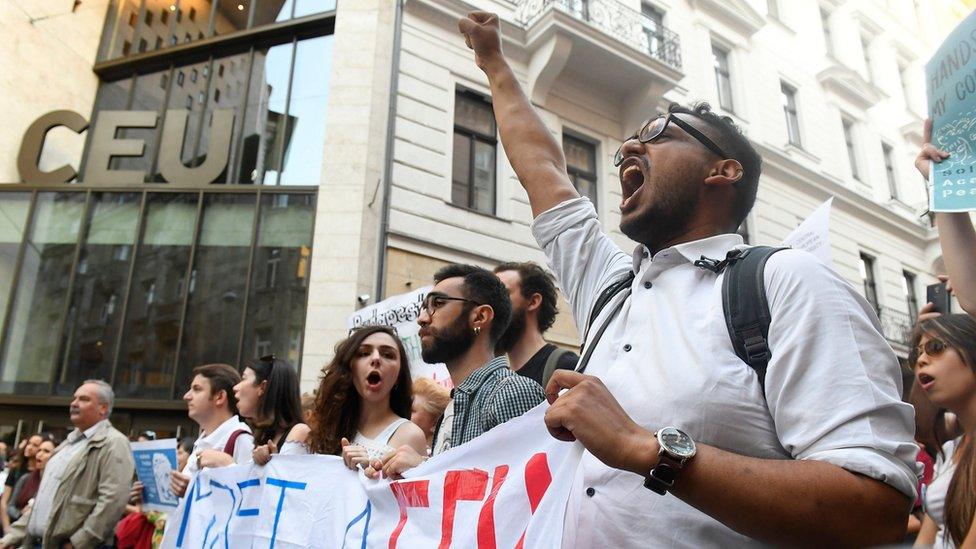 A protester raises his fist outside the CEU university