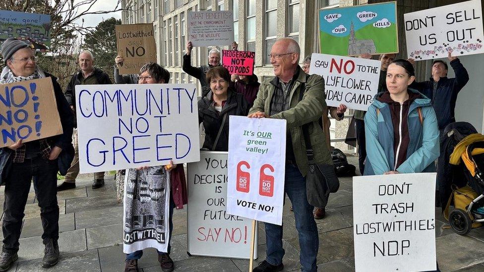 Protesters outside New County Hall holding placards