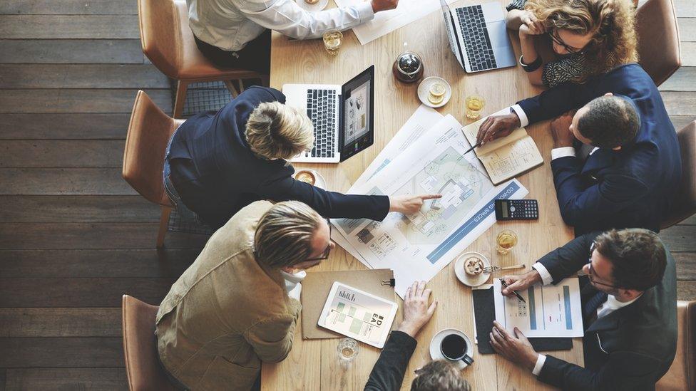 Overhead shot of office workers at a table