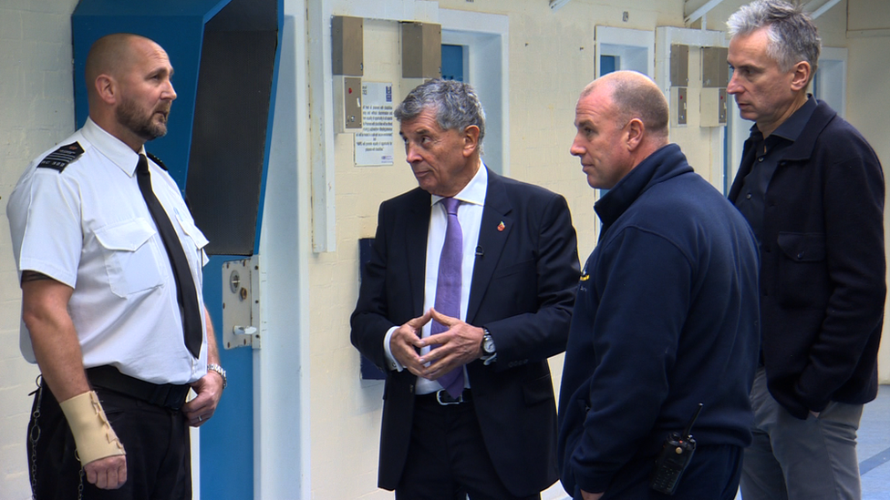 Alan Smith and David Dein with prison staff