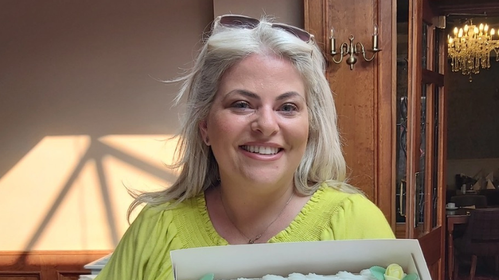 Janet Ward with grey hair, wearing a green top