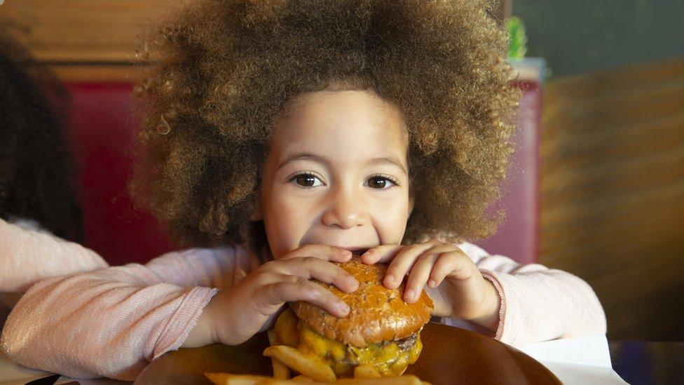 Child-eating-burger.