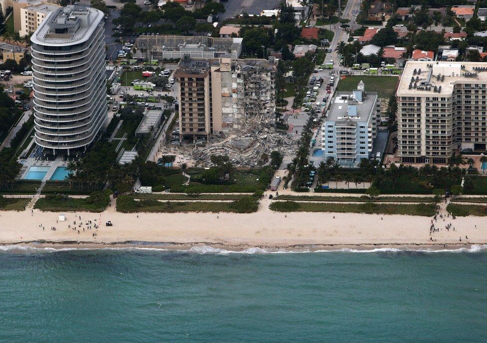 In this aerial view, search and rescue personnel work after the partial collapse of the 12-story Champlain Towers South condo building on June 24, 2021 in Surfside, Florida.