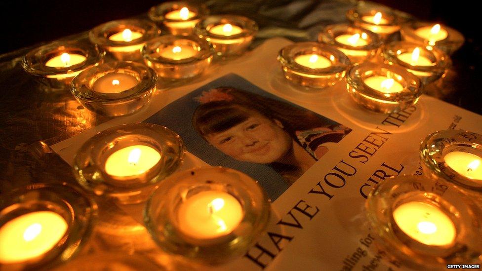 Candles around a missing poster of Shannon Matthews before she was found.