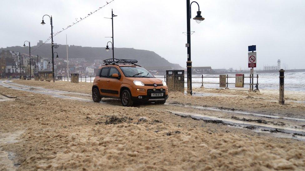 Sea foam covers promenade