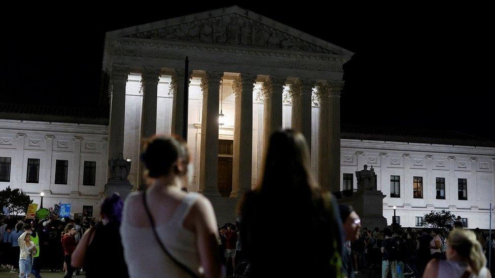 Protesters react outside the Supreme Court