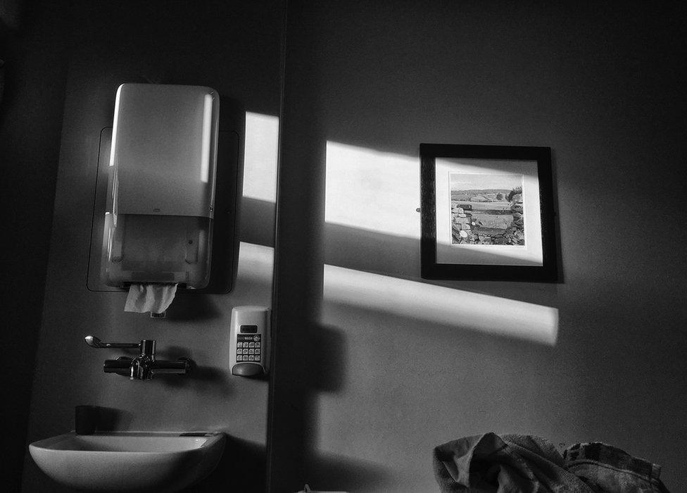 A hospital bathroom showing a sink and soap.