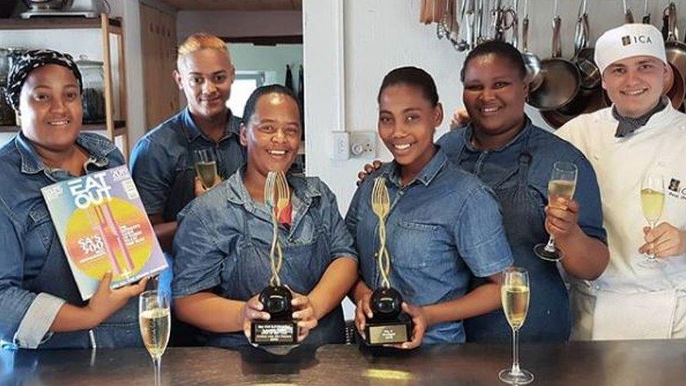 Staff at the Wolfgat restaurant pose with awards they won previously