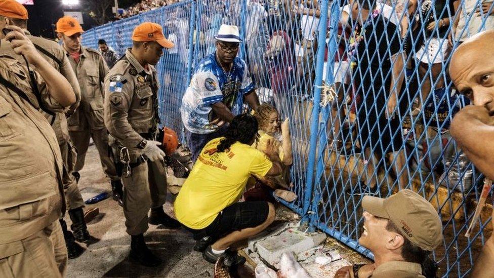 A woman in assisted by firefighters after being run over by a float of the Paraiso do Tuiuti samba school at the entrance of the Sambadrome during the first night of Rio's Carnival, in Rio de Janeiro, Brazil, on February 26, 2017.