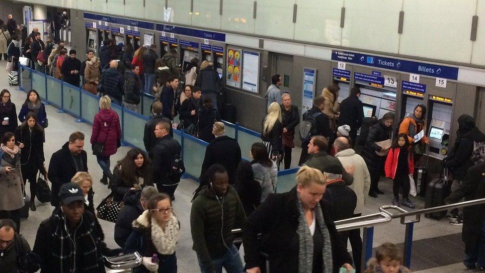 People queuing for ticket machines