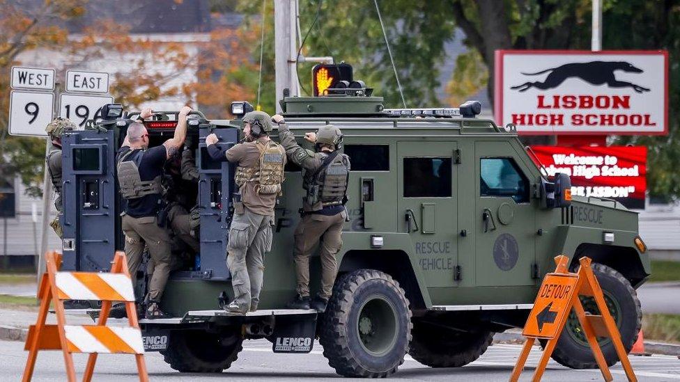 Armed police on a vehicle in a neighbourhood