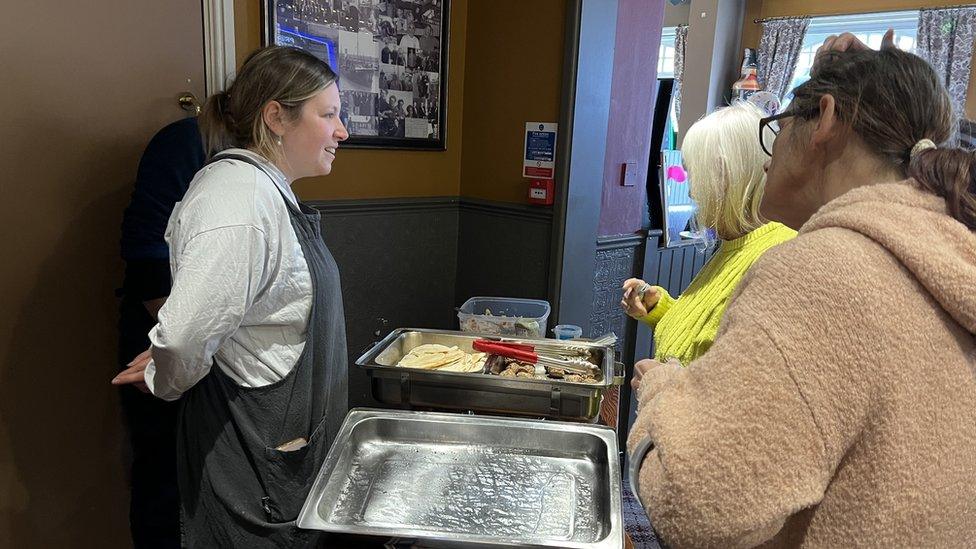 Tina queuing for a hot meal at Rayners pub in Hull