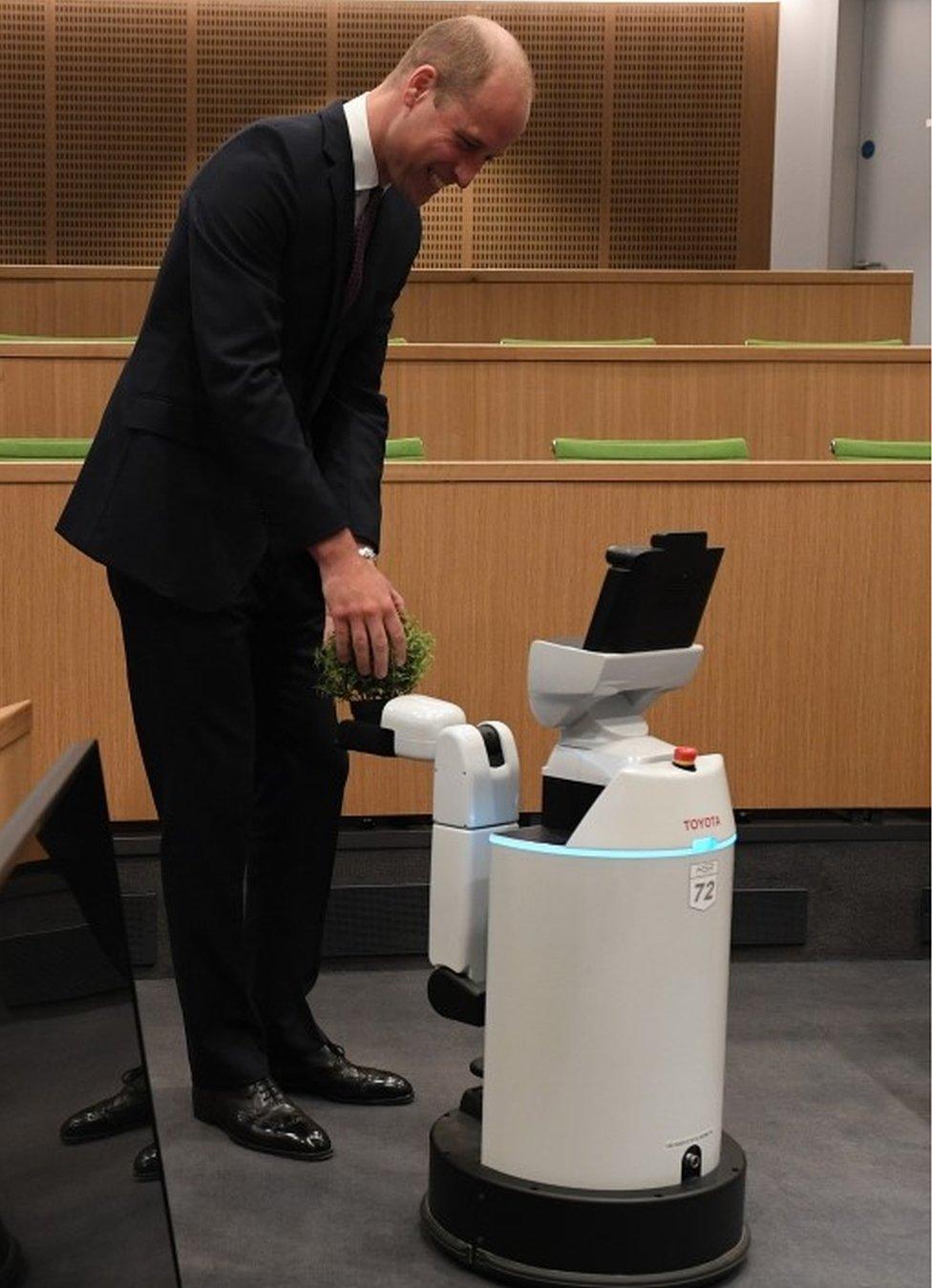 The Duke of Cambridge interacts with Bambam, a robot designed to pick up objects