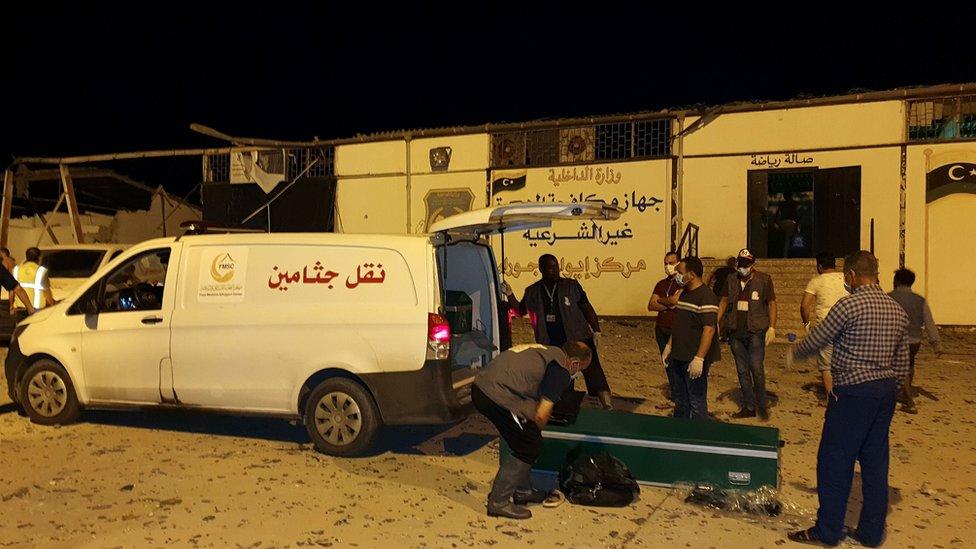 Emergency workers arrive to the scene were an airstrike killed nearly 40 at Tajoura Detention Center, east of Tripoli