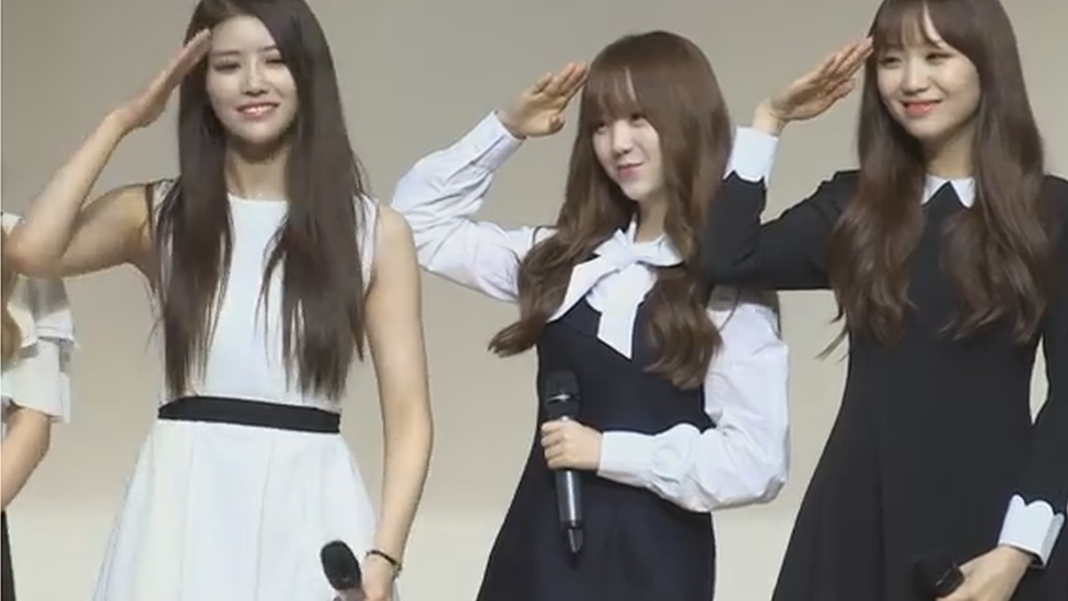 Three members of the group saluting at the event announcing them anti-smoking ambassadors