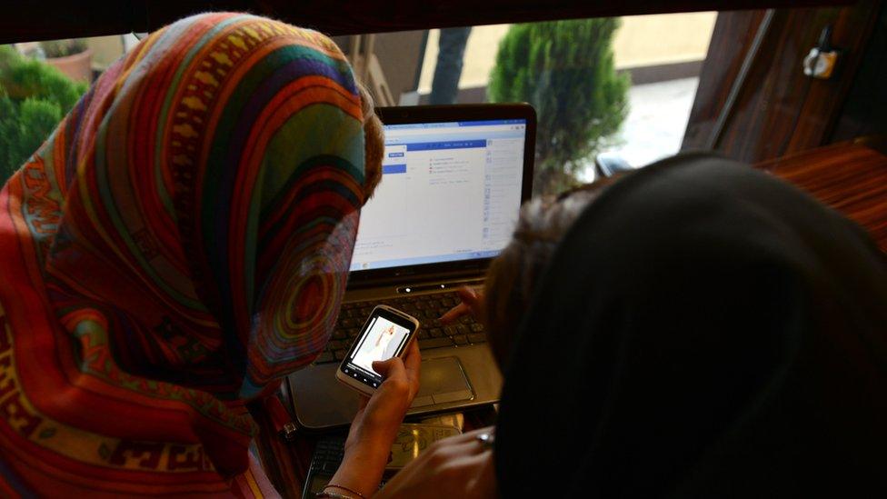 Two woman looking at a phone