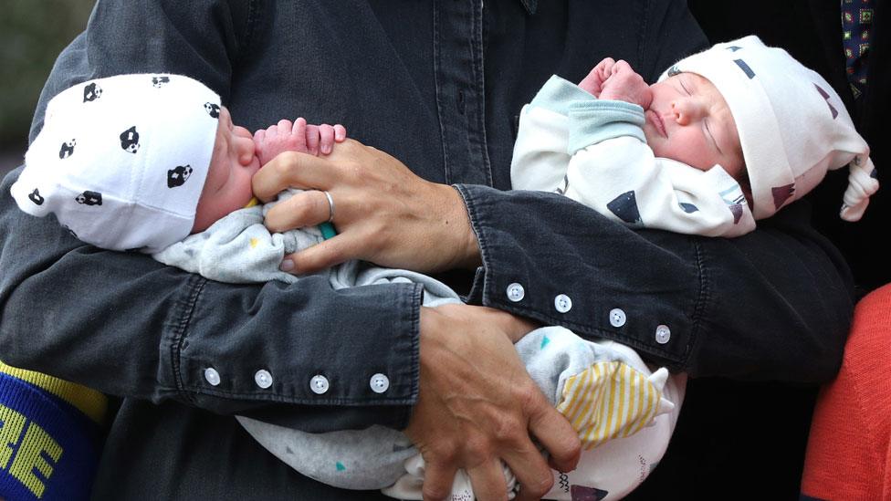 Boo and Walt Evans in the arms of Chris Evans' wife Natasha Shishmanian